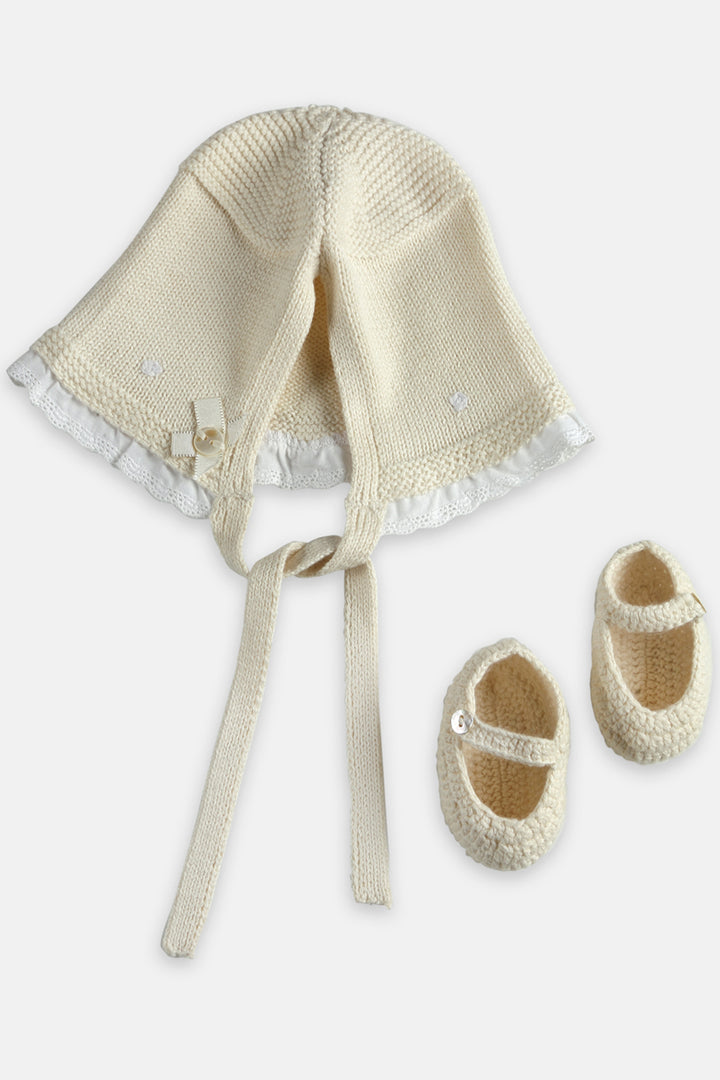 Ivory handcrafted knitted booties and cap set for the baby