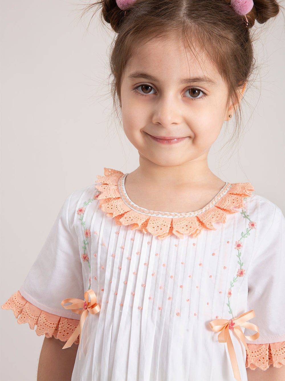 Baby Girl Blush Bow Organic Cotton Dress with a cute side pose