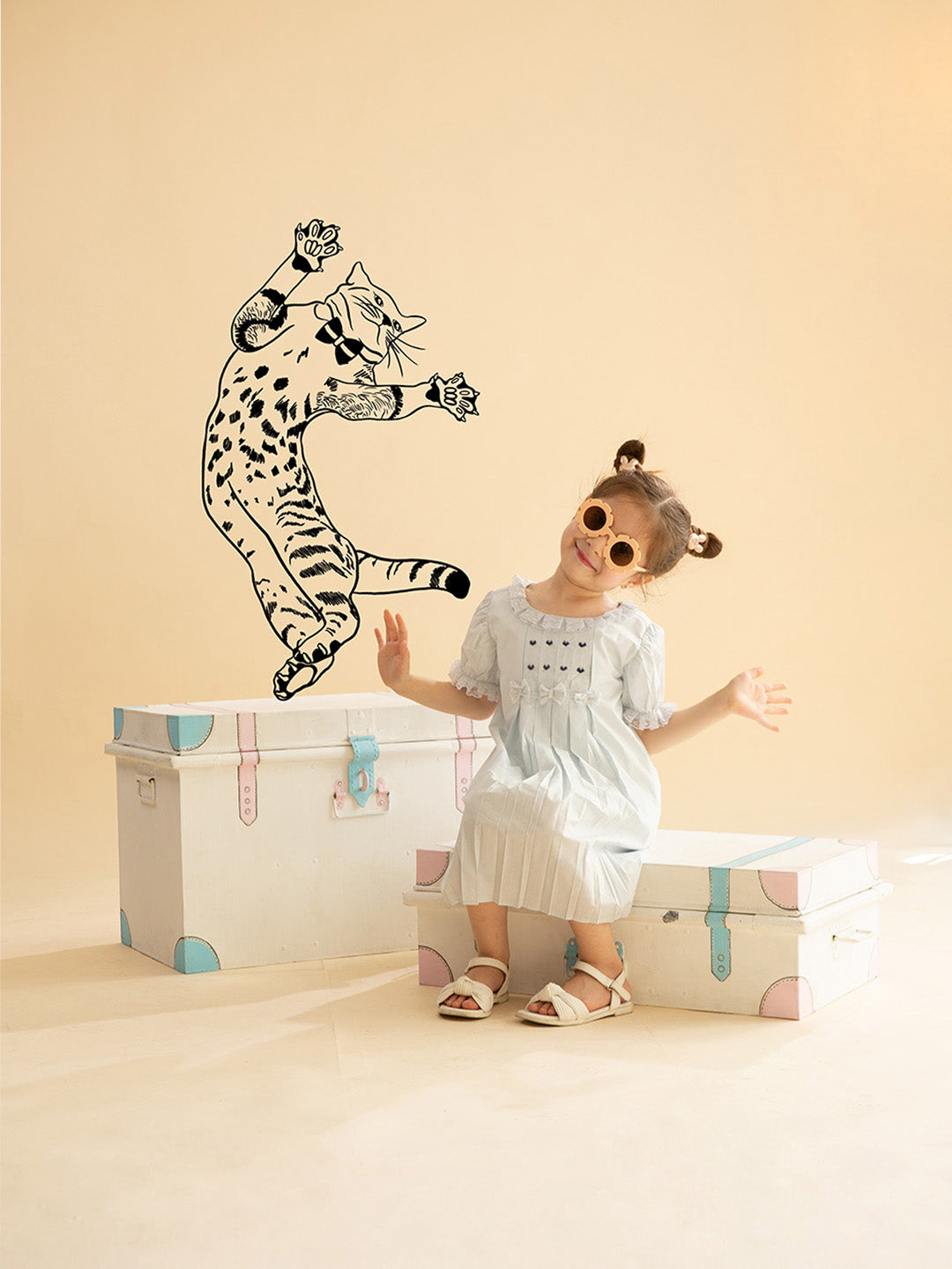 Baby Girl Macaroon Blue Embroidered Organic Cotton Dress sitting on the trunk box