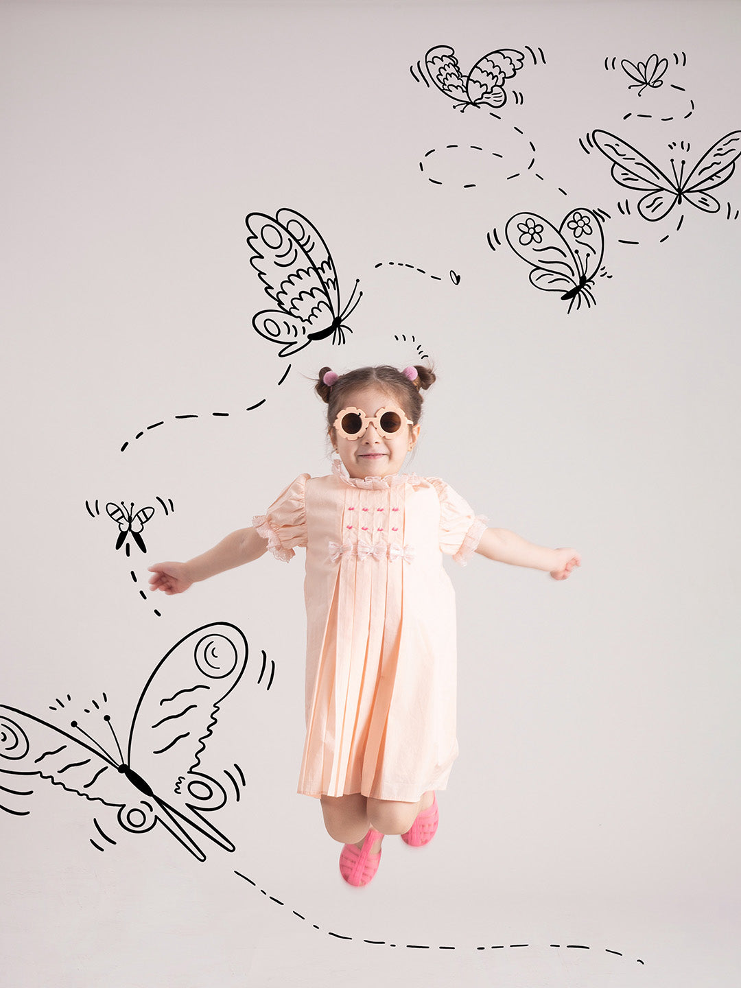 Baby Girl Organic Cotton Peach Bow Dress girl jumping and playing