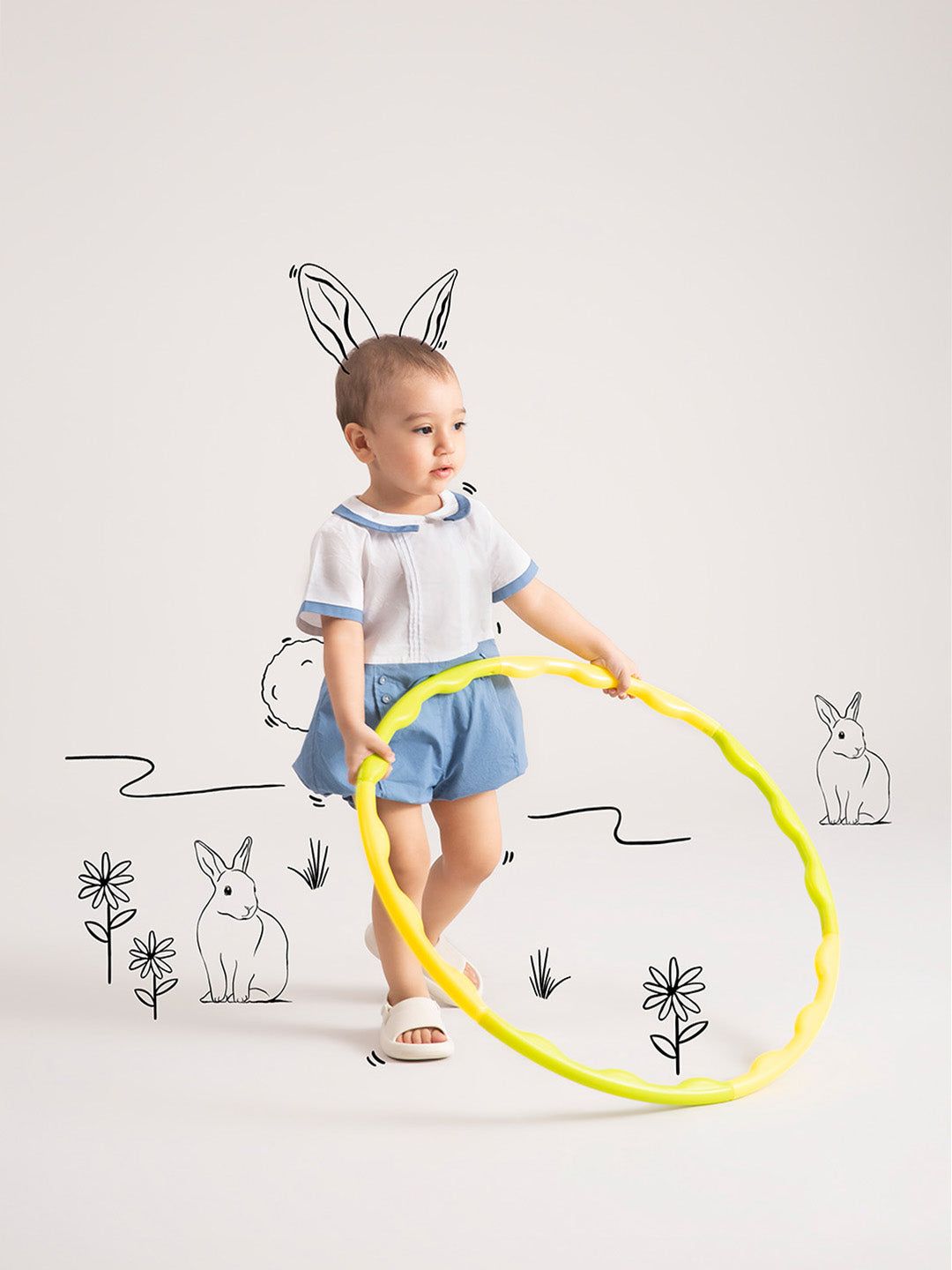 Newborn Baby  Dark Blue Organic Cotton One-Piece with hula hoop in hands