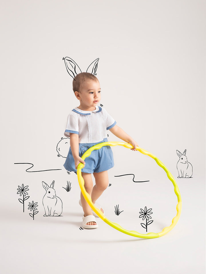 Newborn Baby  Dark Blue Organic Cotton One-Piece with hula hoop in hands