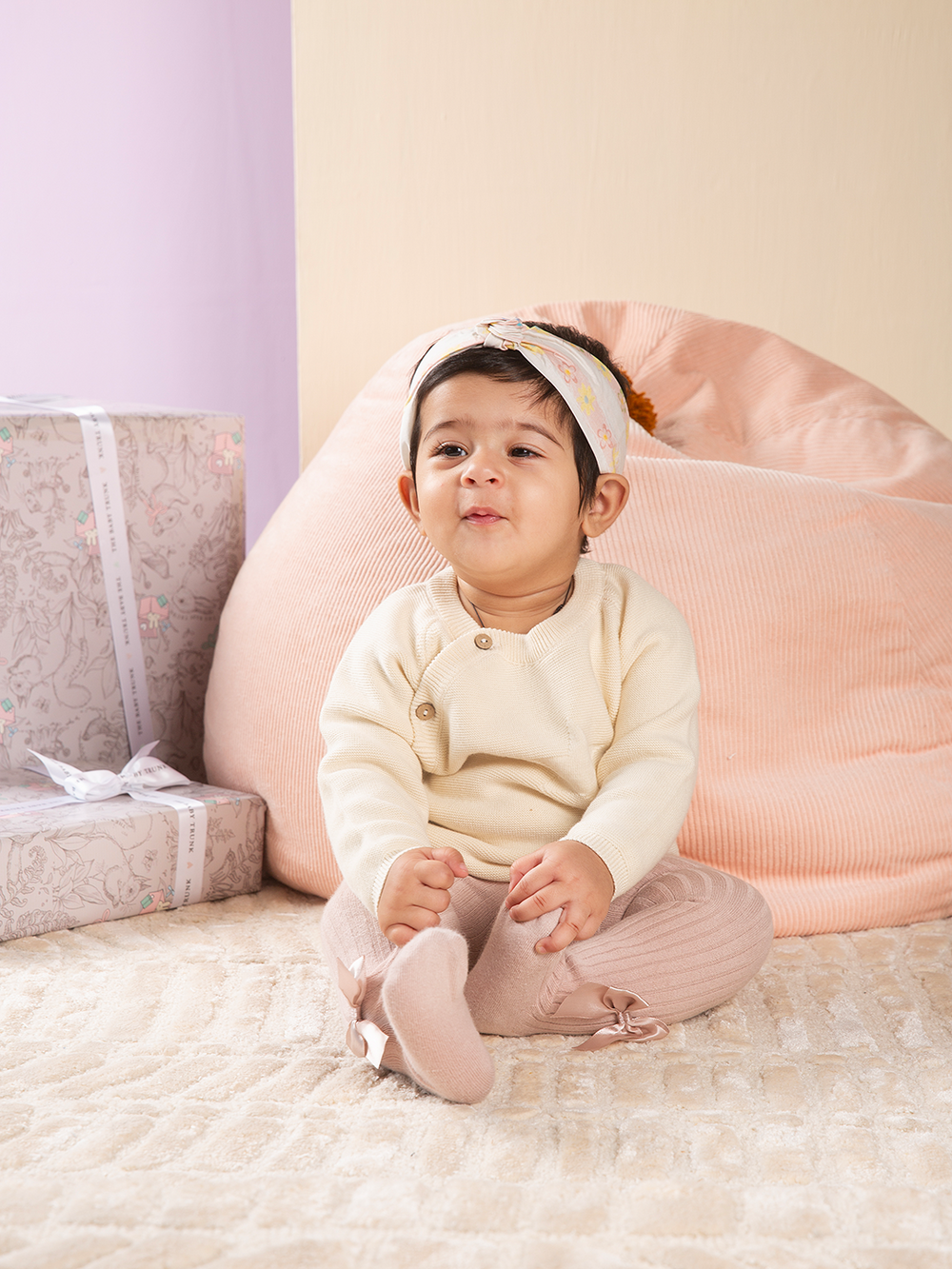baby looking super cute wearing side button cardigan ivory